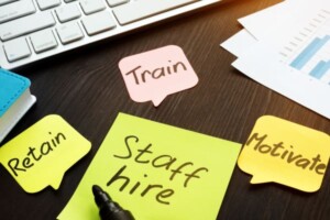 Notes on a desk describing ways to train, retain and motivate staff